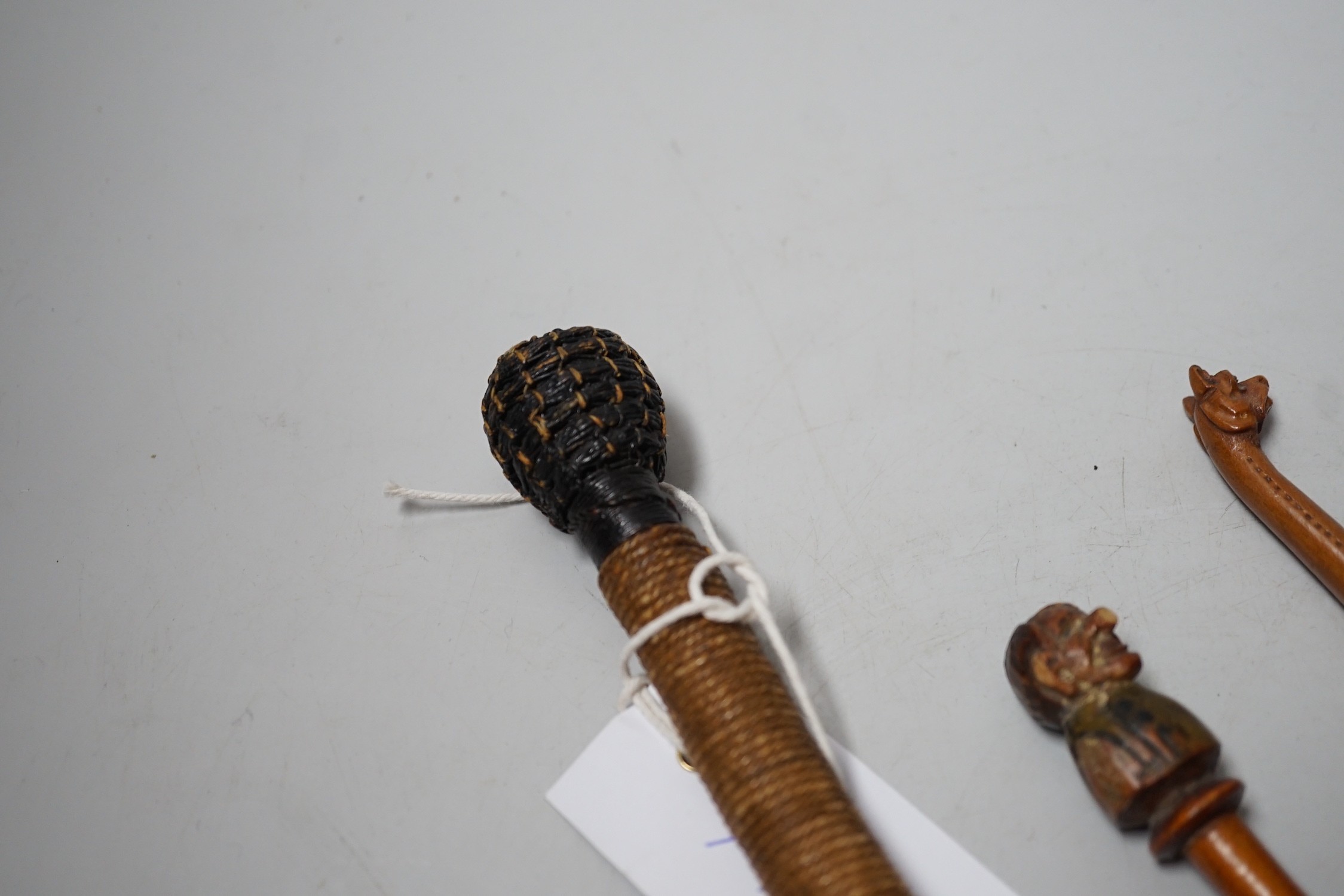A pair of novelty treen glove-stretchers, 19cm, a similar pipe, a mauchline box and a 19th century beater